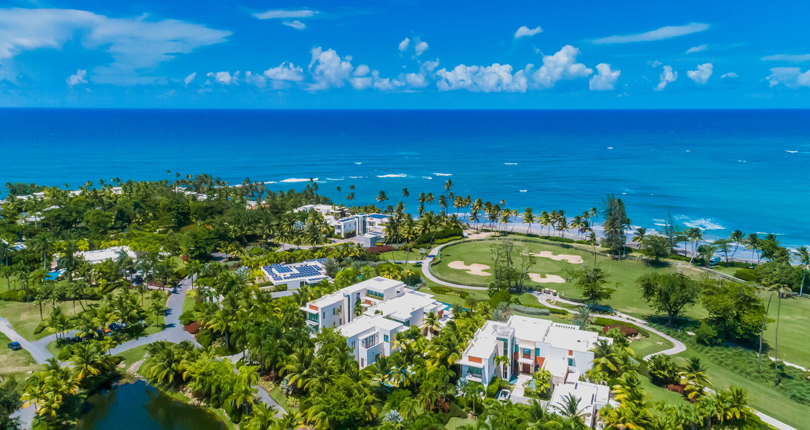 Aerial view of Dorado's resort coastline, golf course, and oceanfront homes.